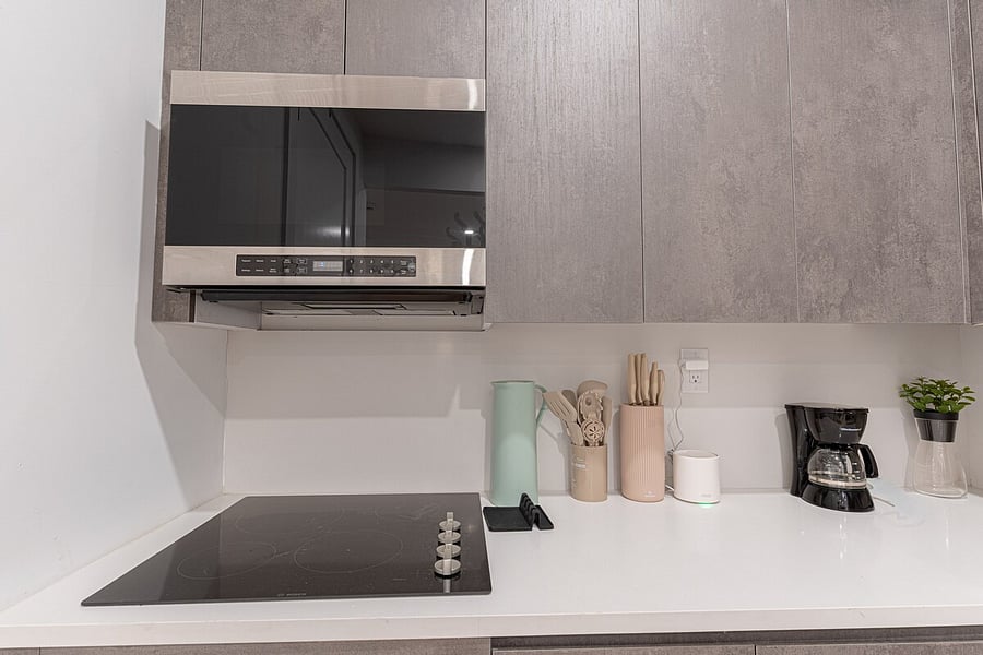 Bright living space with smart TV and exposed brick, opening to the dining nook  a stylish, comfortable retreat.