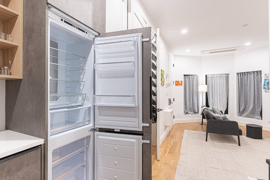 Open studio living-dining with smart shelving and seating for casual meals  a clever, modern layout.