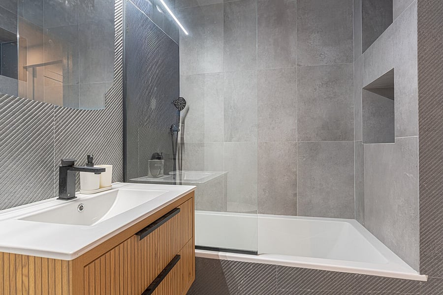 Sleek modern bathroom with a glass walk-in shower and large-format tile  fresh, spotless and ready.