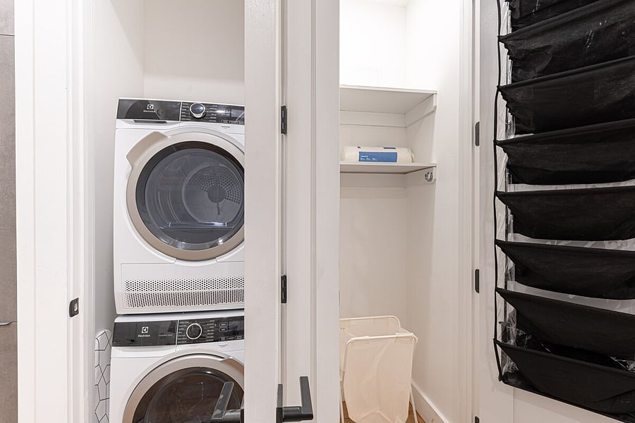 Comfortable bed and a full modern kitchen share this airy studio under exposed brick  smart, renovated living.