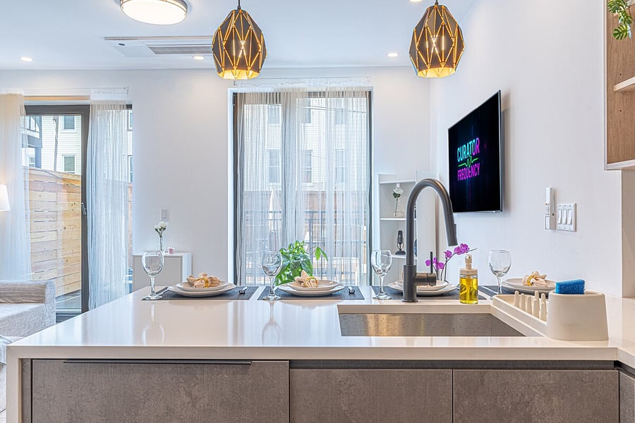 Fully renovated kitchen with a big island, modern fixtures, and bright windows.