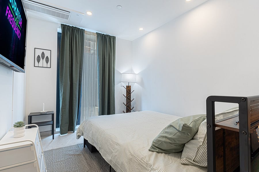 Restful bedroom with a plush queen bed, fresh linens, and a smart TV  a quiet retreat.