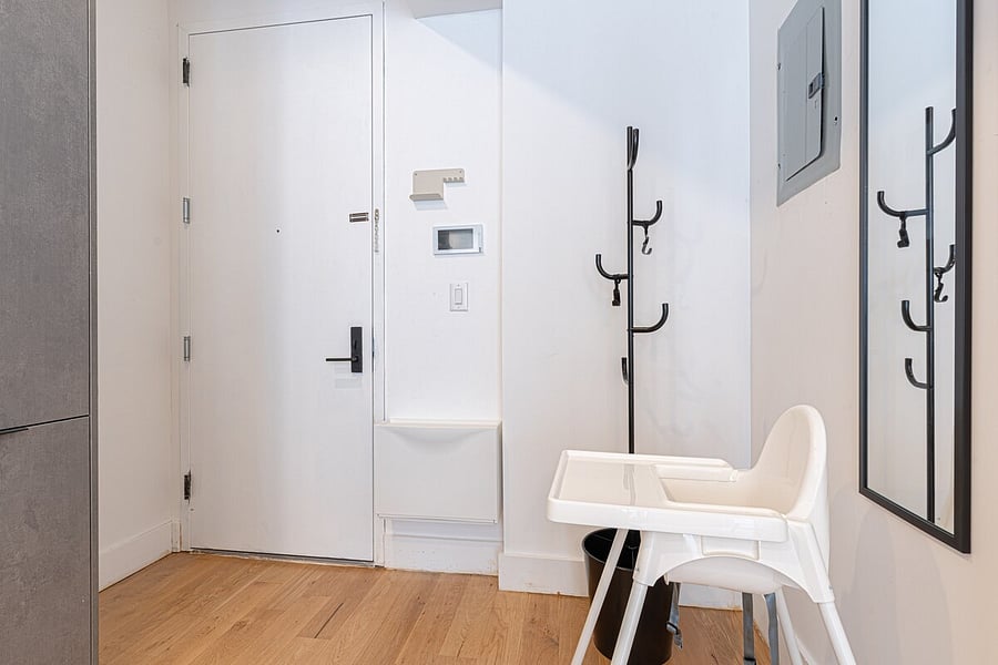 Welcoming entryway with coat hooks and a high chair  family-friendly touches greet you.