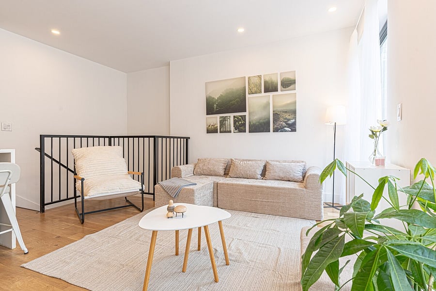 Inviting sofa nook with an accent chair and framed art gallery wall  sink in and relax.