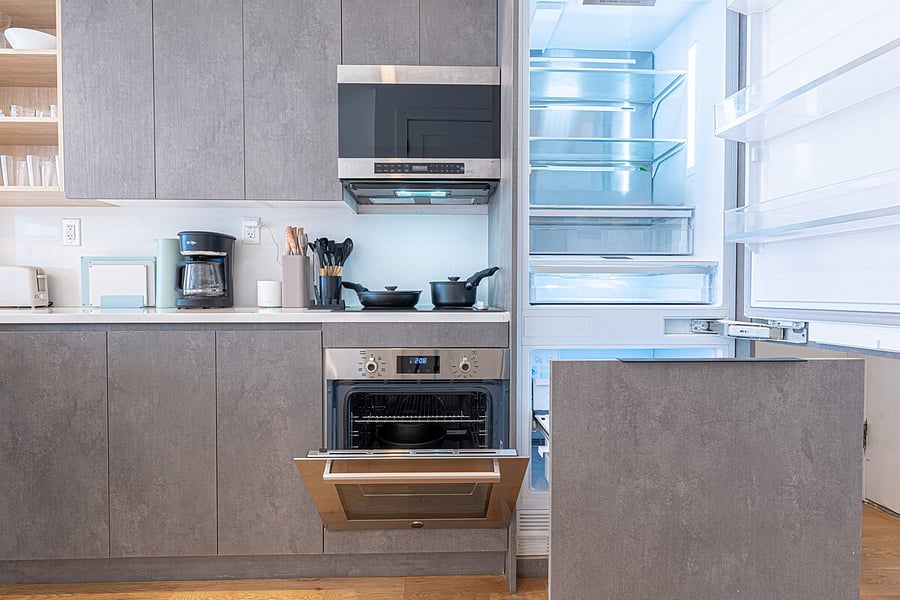 Fully equipped kitchen with stainless oven, microwave, dishwasher, and full-size fridge.