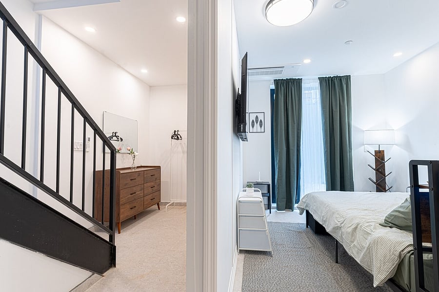Comfortable bed with crisp bedding  a relaxing retreat in the duplex's sleeping quarters.