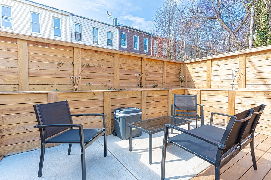 Private fenced backyard with lounge seating  your own outdoor retreat.