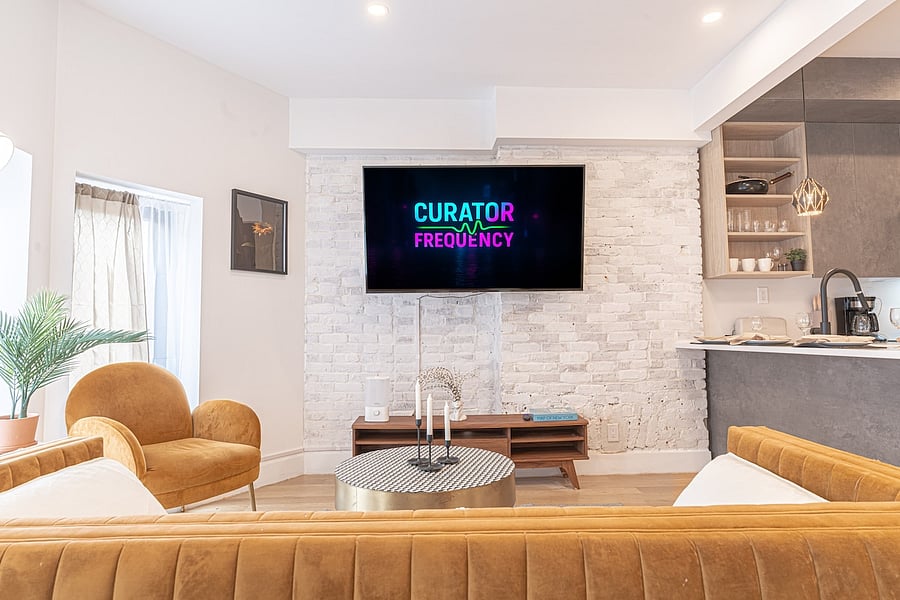 Open lounge with cozy seating flowing into the kitchen  relax and entertain with ease.
