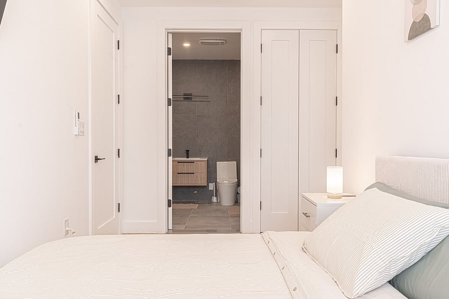 Second bedroom with a plush queen bed and soft linens  a quiet, private retreat.