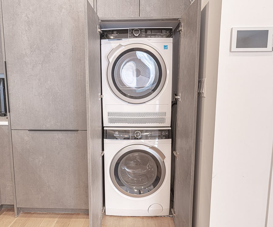 Renovated full bath with a wood vanity and glass walk-in shower  clean and modern.