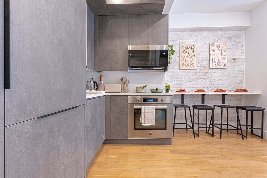Modern full kitchen with a breakfast bar and full-size appliances.