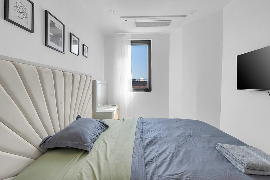 Bright hallway leading past the bath toward the bedrooms of this renovated 2BR.