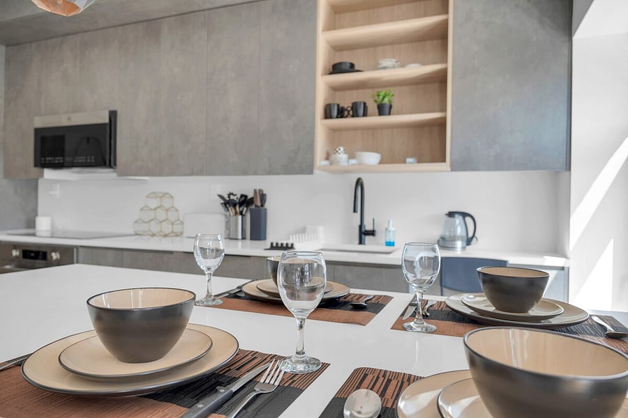 Modern full kitchen with an island, bar seating and stainless appliances.