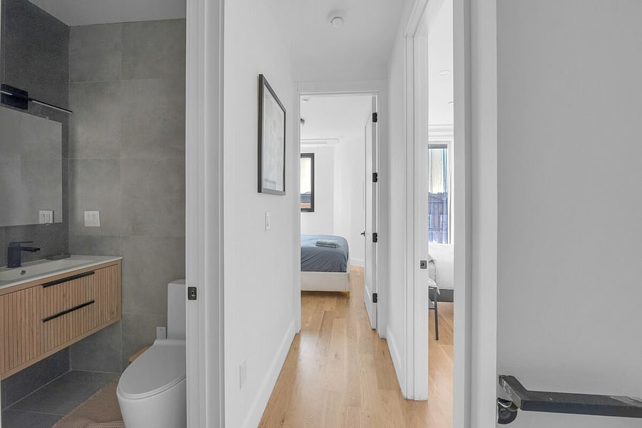 Bedroom with sliding doors opening to a private balcony.