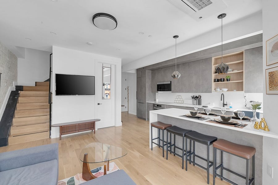 Expansive open kitchen and living space with arched windows and natural light.