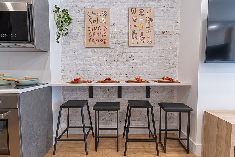 Glassware and essentials stocked on open shelving  this fully equipped kitchen has it all.