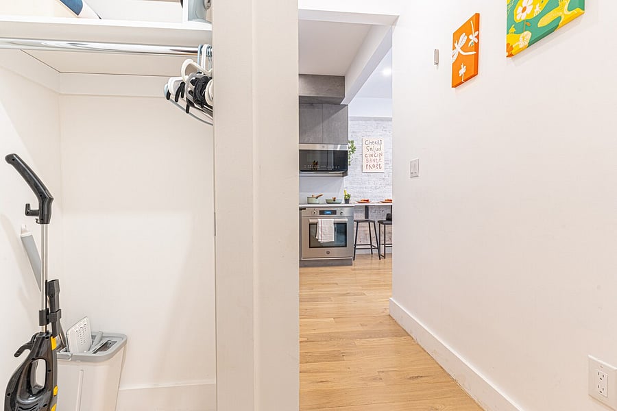 Renovated bathroom with a warm wood vanity and full shower.