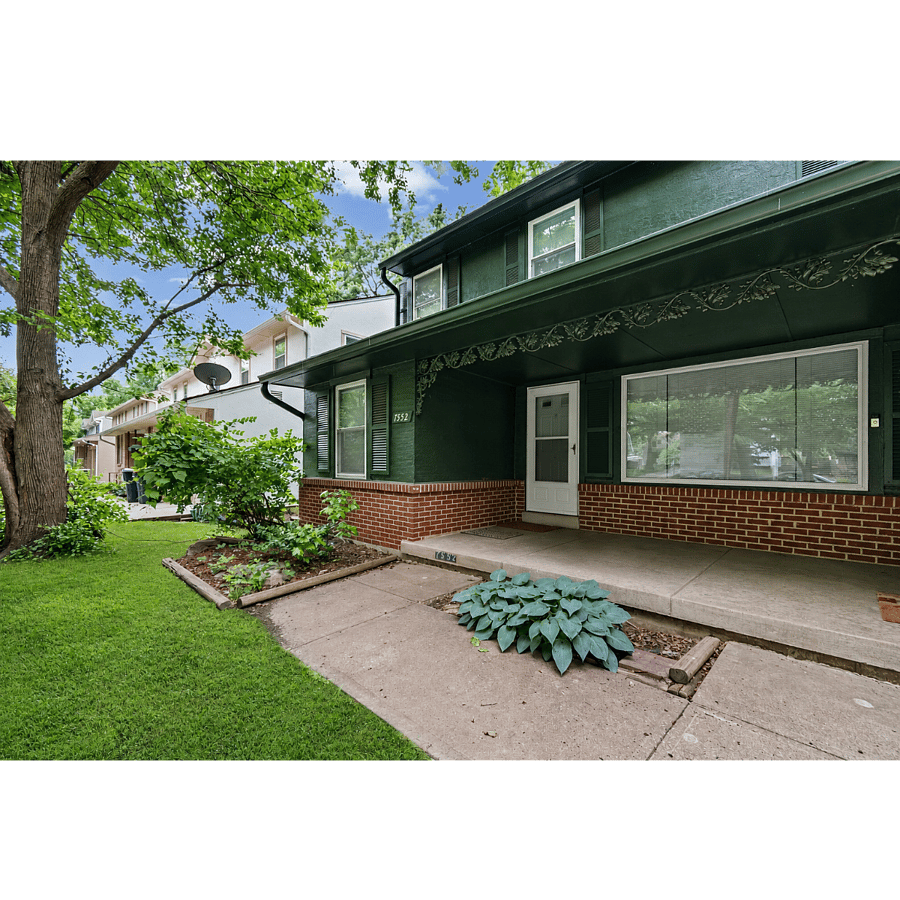 Front exterior. Classic Kansas City character from the curb. Brick front, covered porch, mature trees, and a quiet residential street in Waldo. Off street parking at the home. Welcome to your future home!