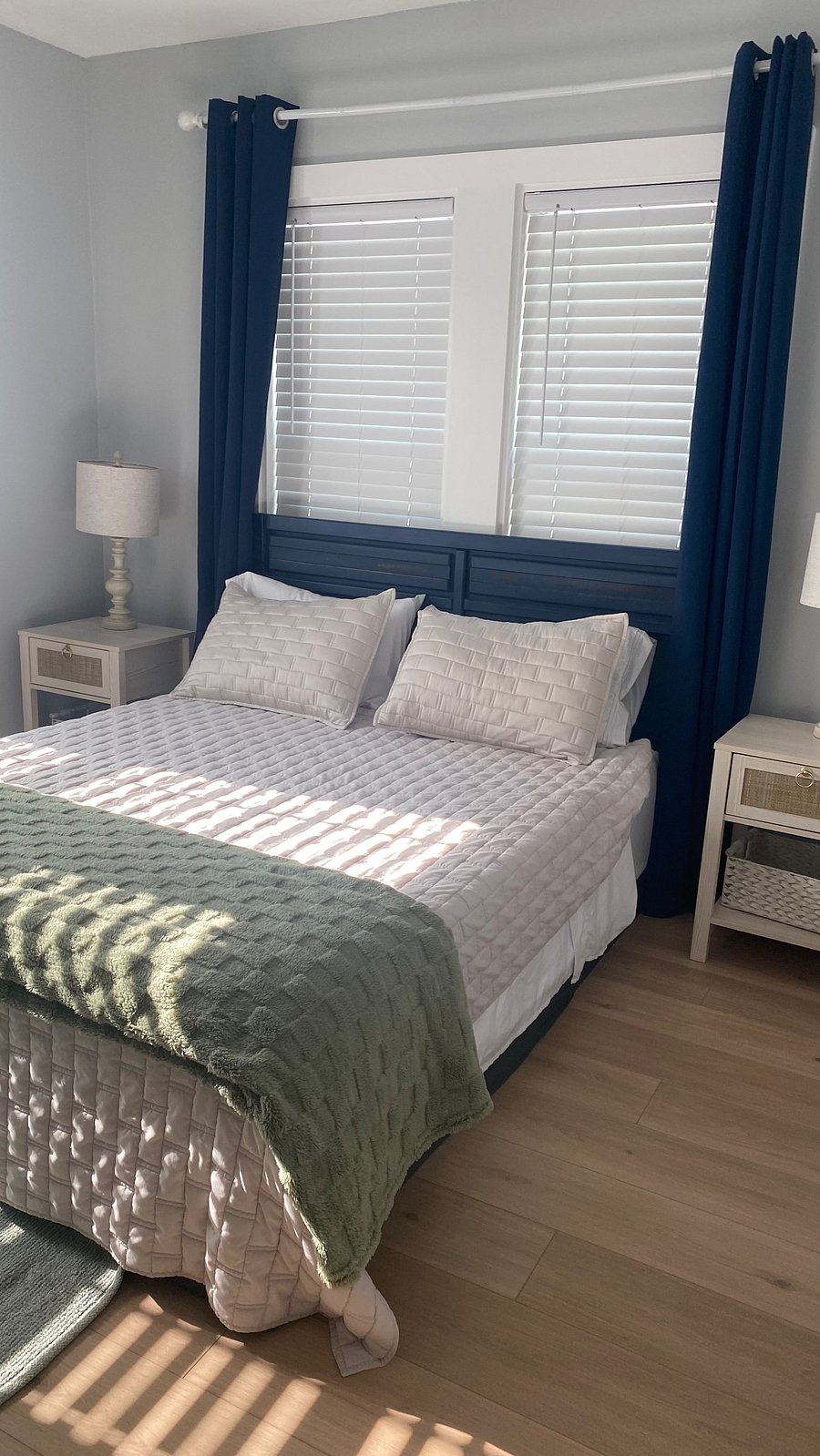 "Comfortable second bedroom featuring coastal decor and flat screen TV