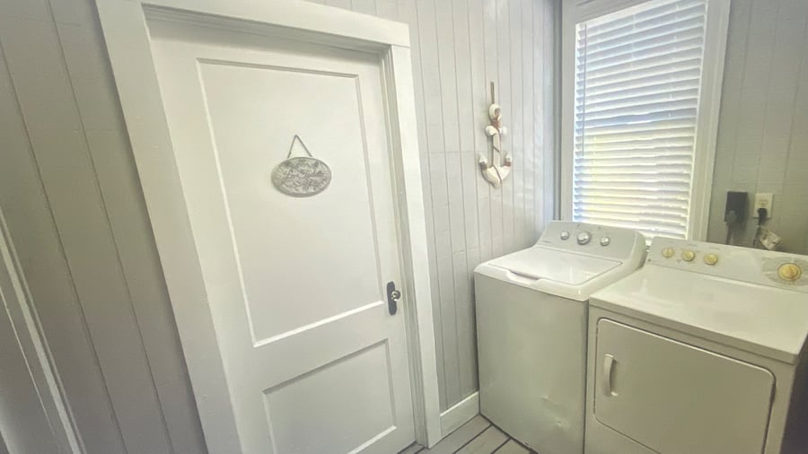 "Convenient laundry room located just off the large outdoor deck, making it easy to refresh beach towels and clothing after a day at the beach.