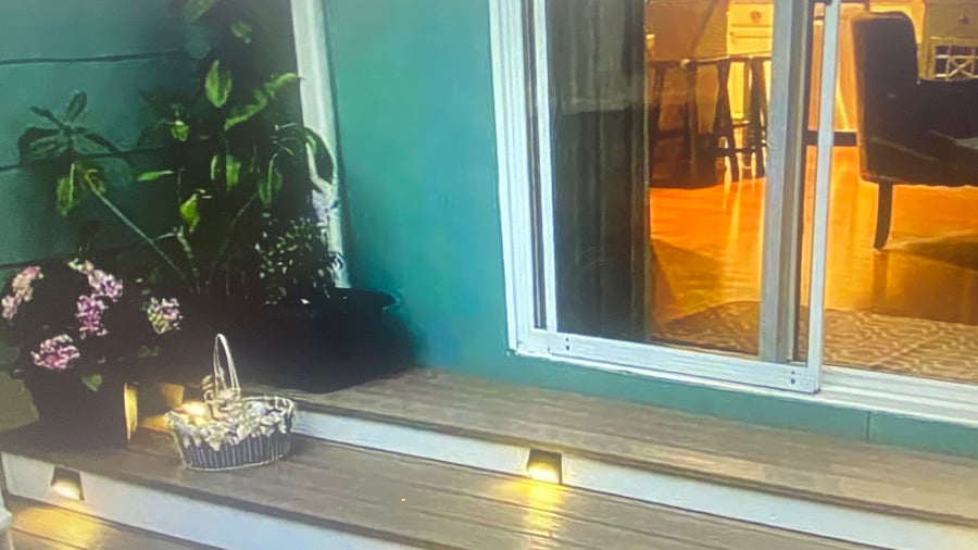 "Bright and inviting living room featuring a sliding glass door that opens directly onto the spacious outdoor deck.Specious private deck featuring a dinning table 