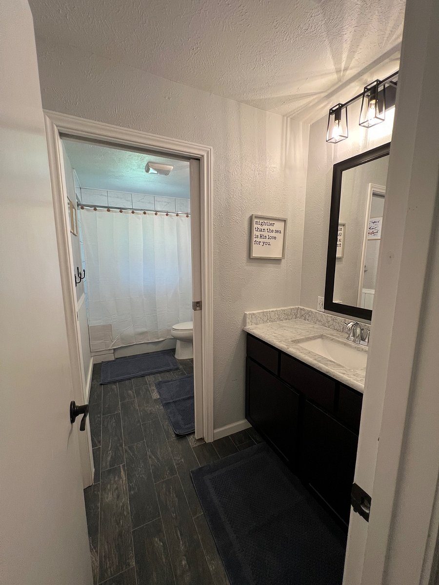 Guest bathroom with double sinks and a tub/shower combo.