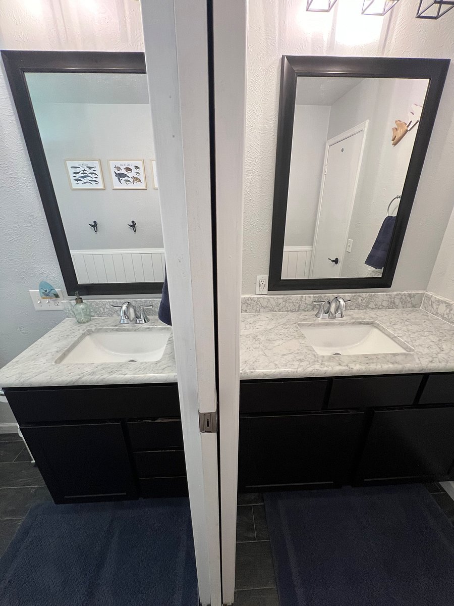 Pocket door between the double sinks for privacy.