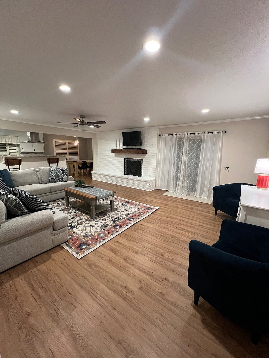 This living space is beautifully central to the home with a gas fireplace and smart TV along with a sliding glass door, perfect for kids, pets, and grilling outside!