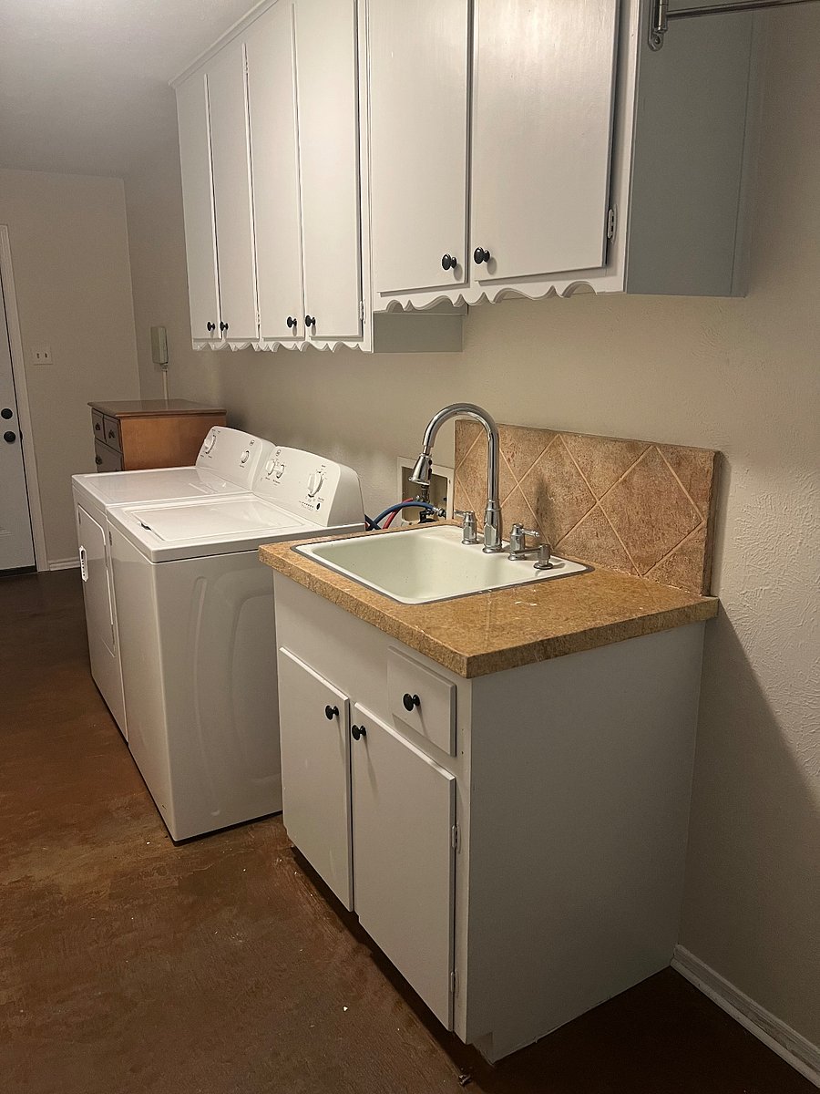 Fully equipped indoor laundry room between kitchen and garage.