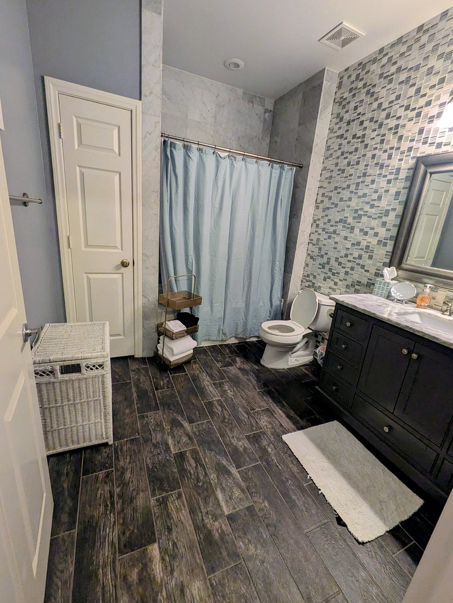 Second bath with tub, shower, and vanity.