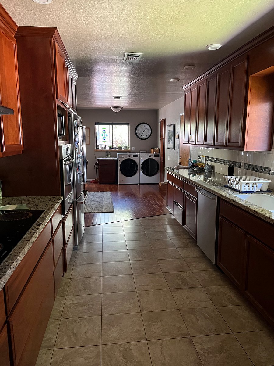 Kitchen includes induction stove top, air fryer, microwave, dishwasher and refrigerator with ice machine.