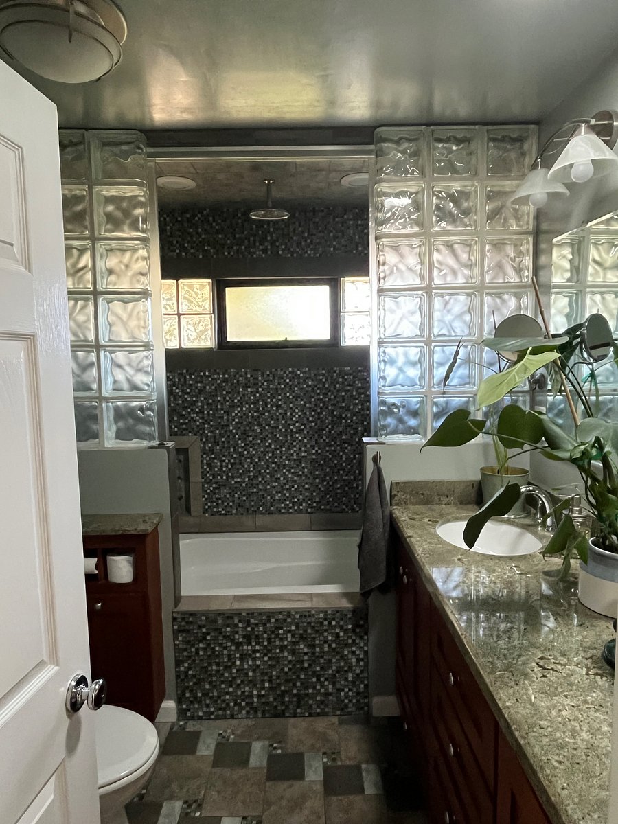 Custom bathroom with waterfall shower and deep tub.