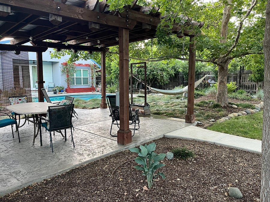 Another view of back yard with hammock, pool and water feature.
In the background is the pool house (occupied by one tenant).