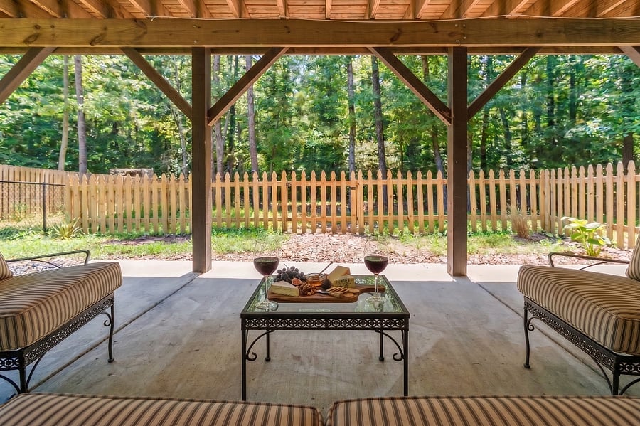 Private fenced patio.  This yard is just for you.  The remaining yard is shared.  There is a ceiling fan just above this sitting area and an outlet behind the sofa for charging your phone or laptop.  