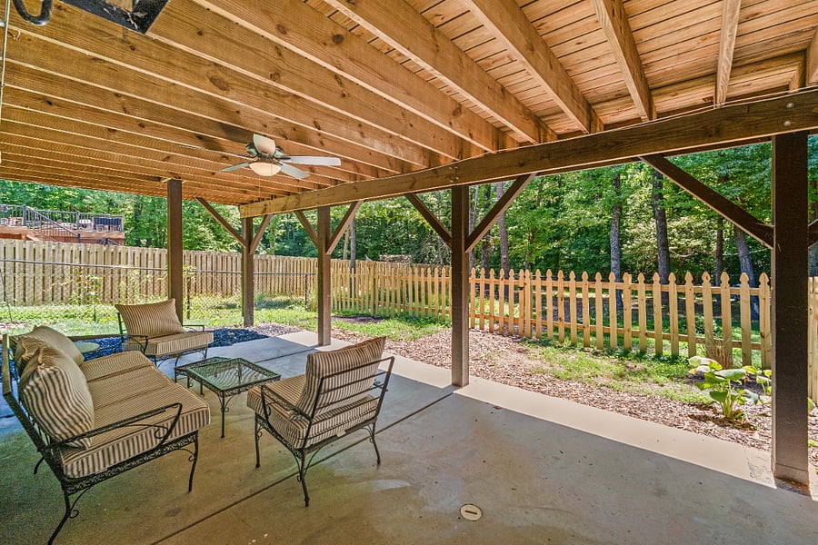 Private fenced patio.  This yard is just for you.  The remaining yard is shared.  There is a ceiling fan just above this sitting area and an outlet behind the sofa for charging your phone or laptop.  