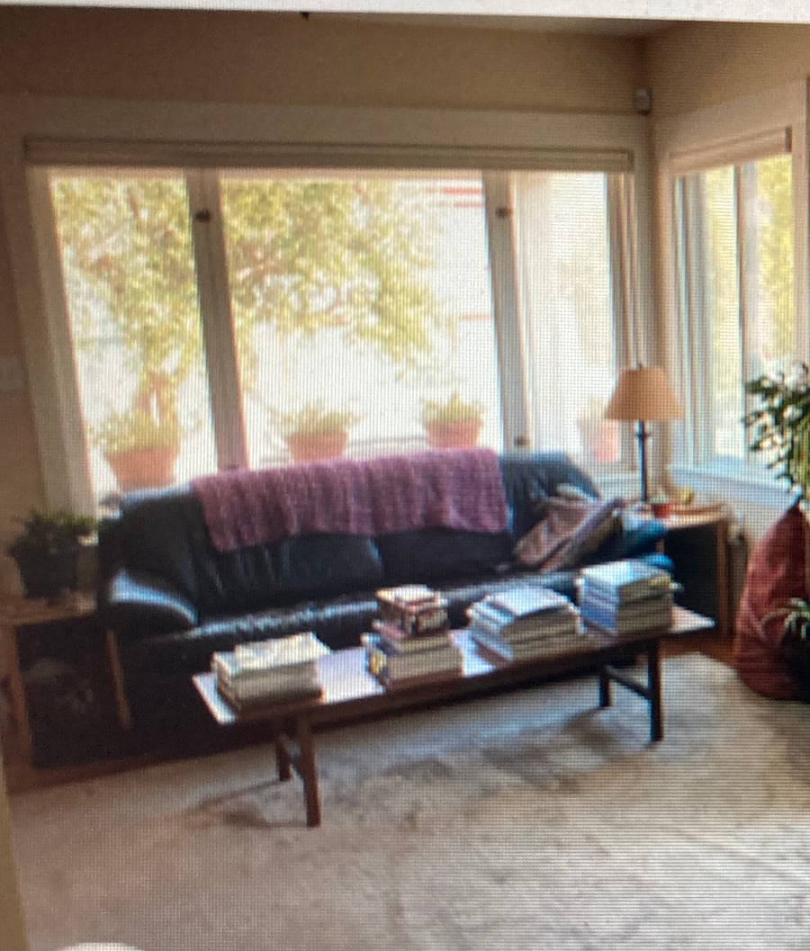 View from dinning room to living room, front window, and porch