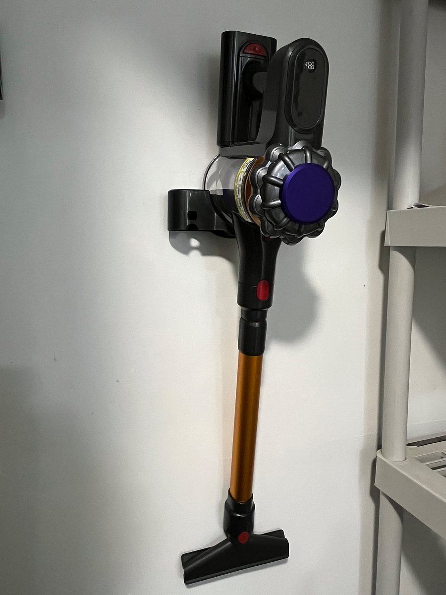 Small utility closet with iron, vacuum, etc.