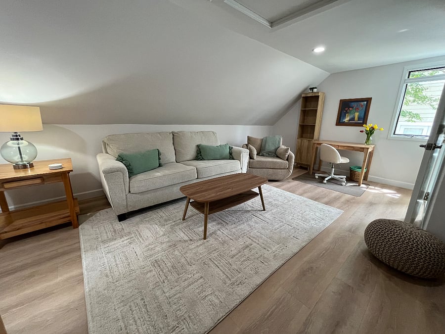 Upstairs living room area with desk and second large TV.