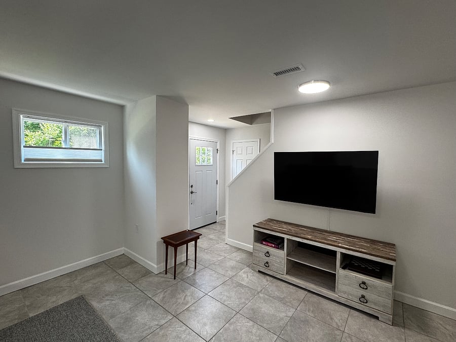 Lower level with large TV and small closet for coats, etc.
