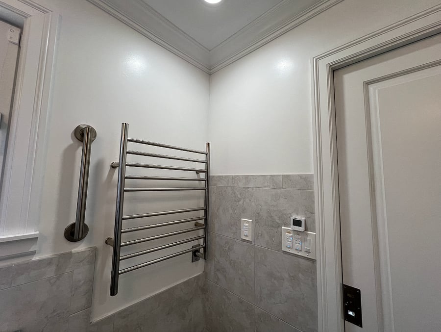 Towel warmer, bathroom heater, fan, and privacy windows for ventilation and natural light.