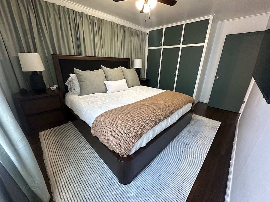 The primary bedroom has a solid, king-sized bed, blackout curtains, large smart TV, bedside tables with lamps and usb/usc plug-ins, and an Alexa.