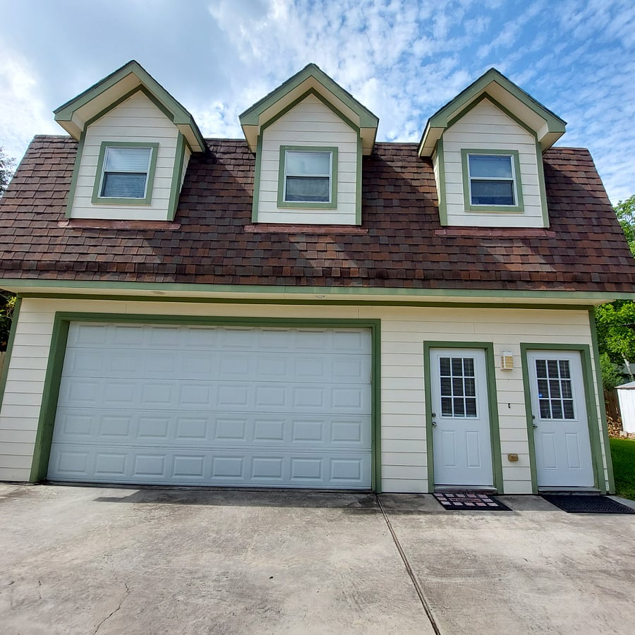 Garage and second floor apartment.  Door to apartment is on far rightside of photo.  The other door is a separate entrance into the garage.