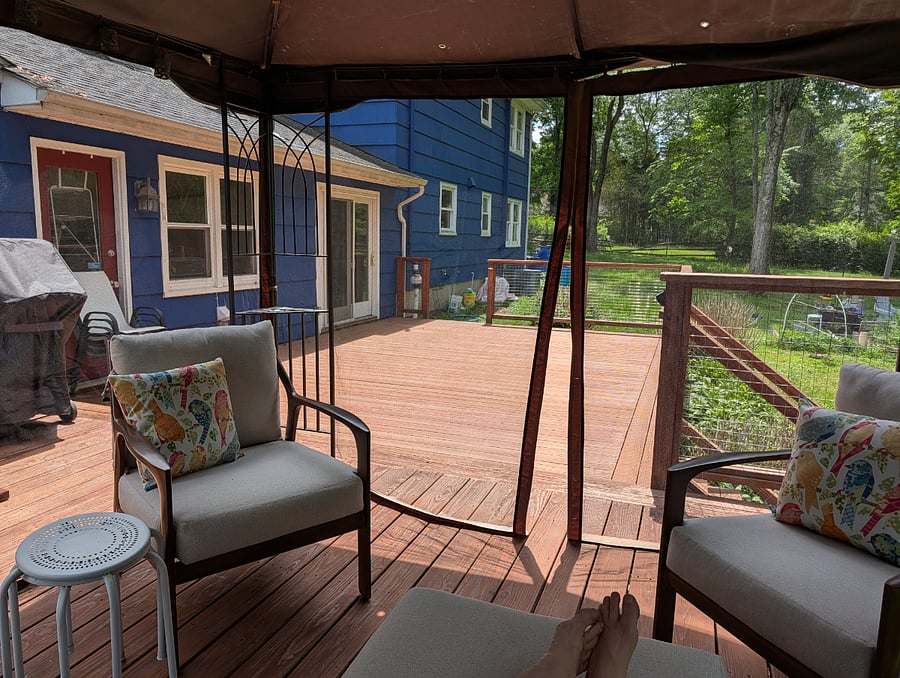 View from insdie the screened gazebo with comfy patio furniture