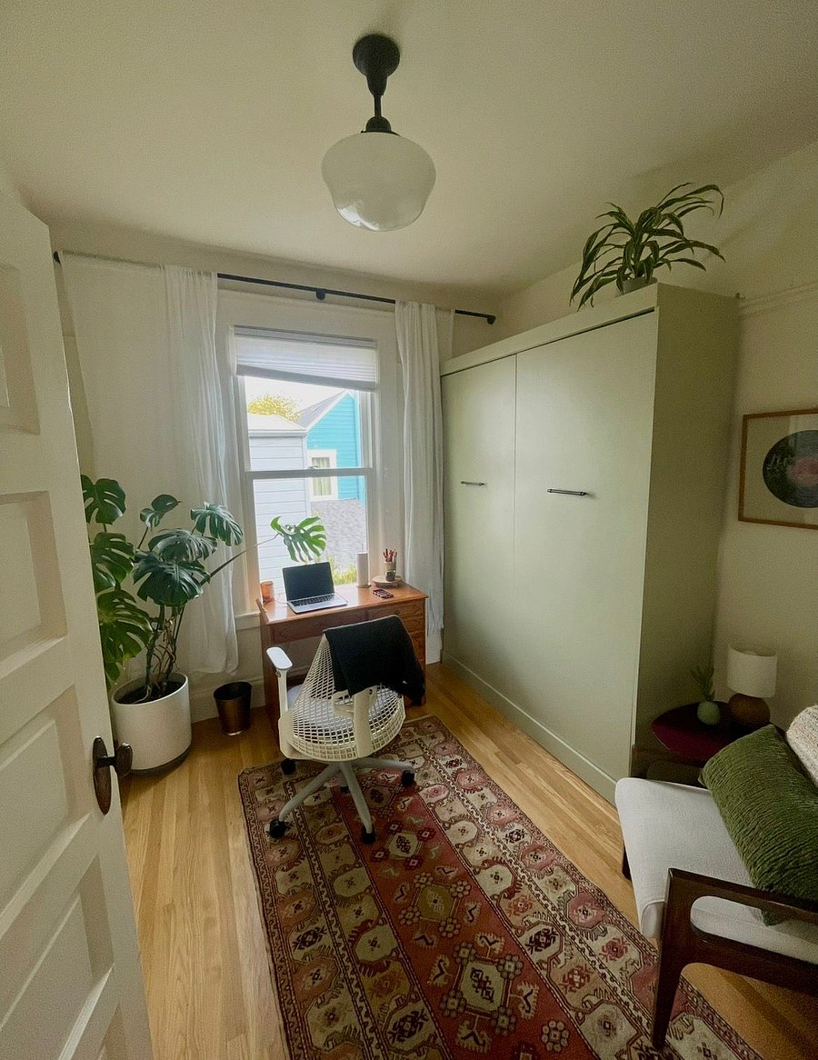 The office is also upstairs. This room is best used as an office, and the murphy bed (green) is queen size with a real mattress. It's great for guests, but since it takes up most of the room, would feel too small for someone to use as their room for an extended period. This room gets amazing natural light. There is also a good size closet in this room.