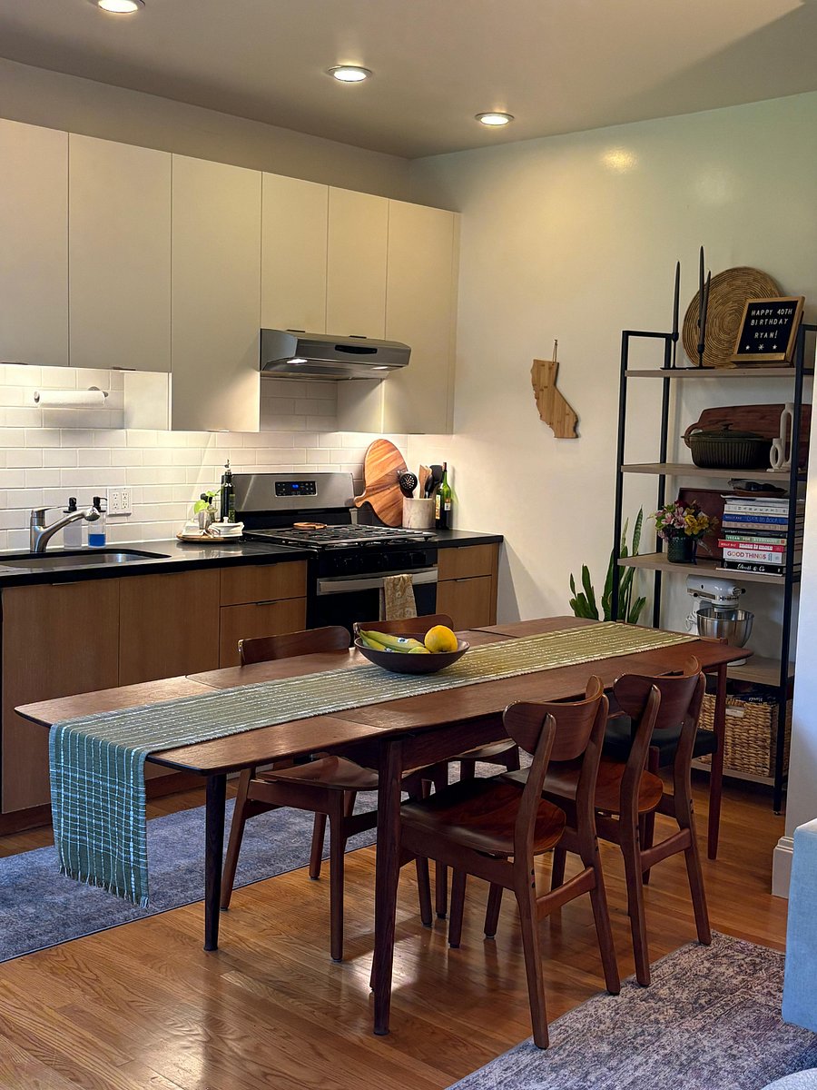 The laundry room and pantry are to the right of this shelf. The dining table can extend to seat up to 10 people.