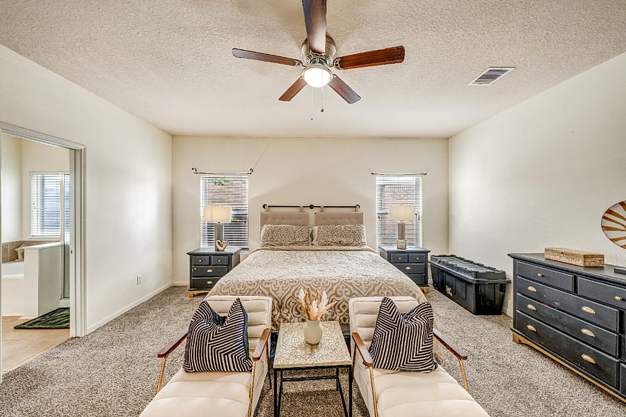 Spacious primary suite featuring a comfortable bed, Smart TV, ample storage, and plenty of room to unwind.