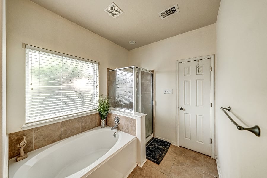 Private en-suite bathroom with a large soaking tub, separate shower, and plenty of counter space for your daily routine.