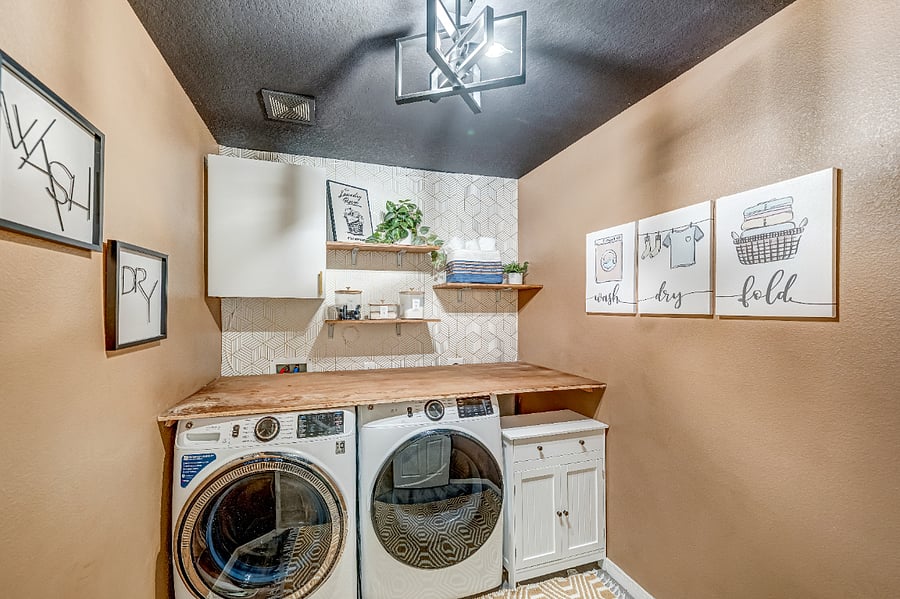 Dedicated laundry room with a full size washer and dryer, providing the convenience of doing laundry from the comfort of home during your stay.