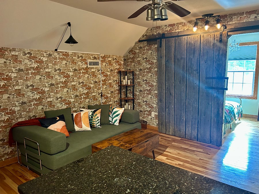 Authentic barn door separates the bedroom from living space