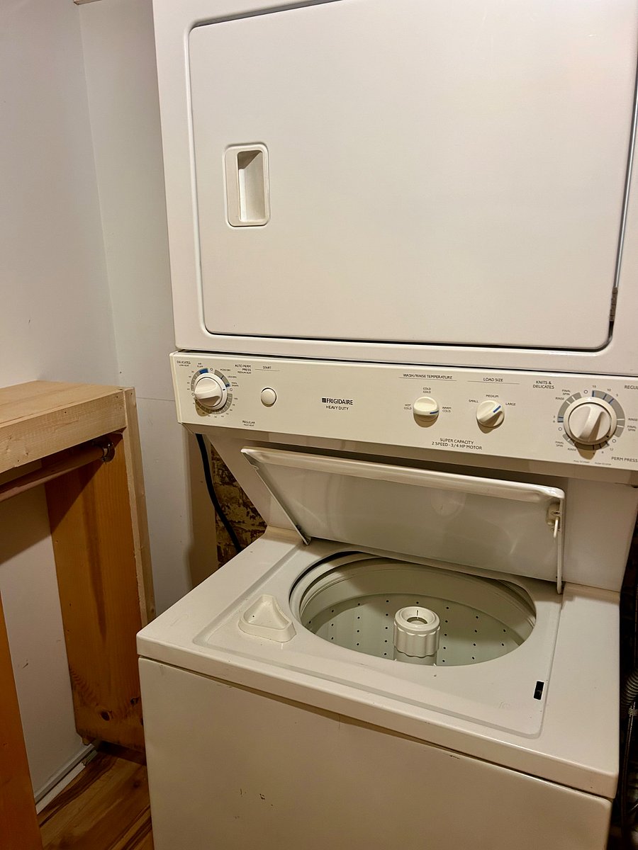Washer and dryer in unit with a dehumidifier right next to it to get clothes dry fast